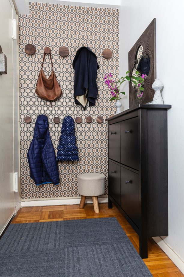 small enclosed entryway with medium tone wood flooring