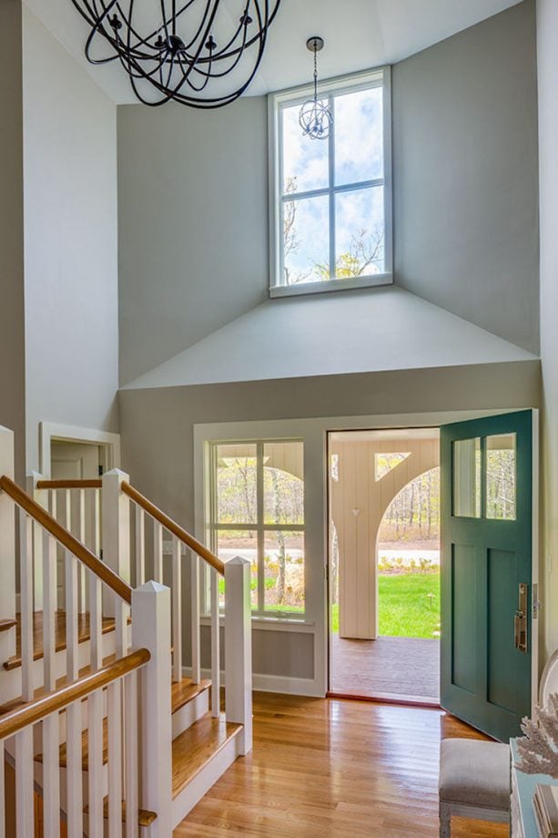 beach style entryway with a bold teal front door