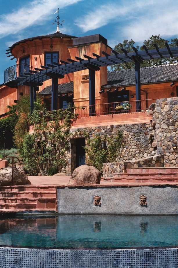 orange stucco exterior and black roof color scheme to create a mediterranean style