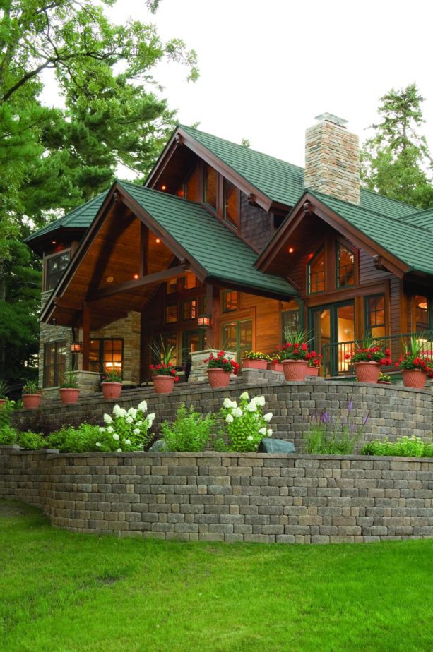 mountain style two story log cabin with shingles in sage green color of metro shakes