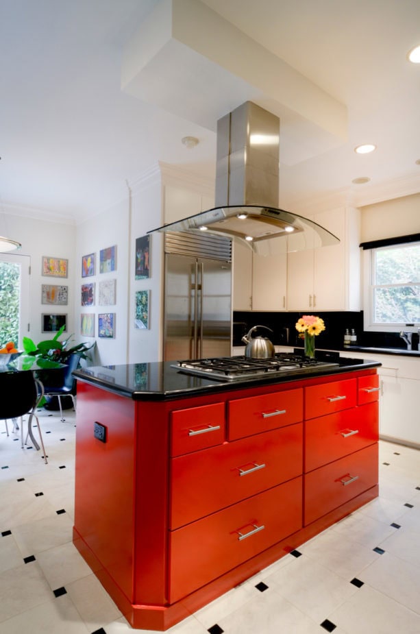 a contemporary kitchen with stunning red kitchen island with black top