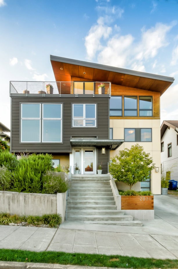 beige, metal, and natural wood house color combination with a shed metal roof