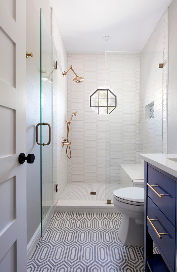 transitional white master bathroom with blue cabinets and without tub