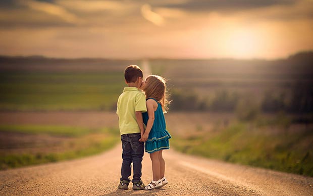 Children (kids) kiss on the road