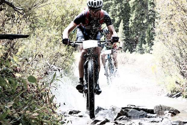 Mountain bikers on a rocky riverbed