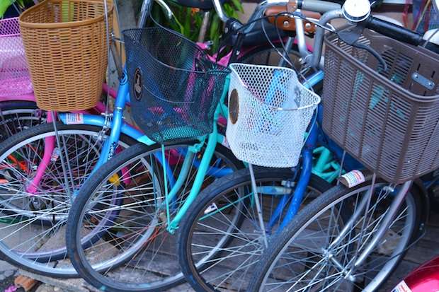 A row fo bikes with colorful baskets