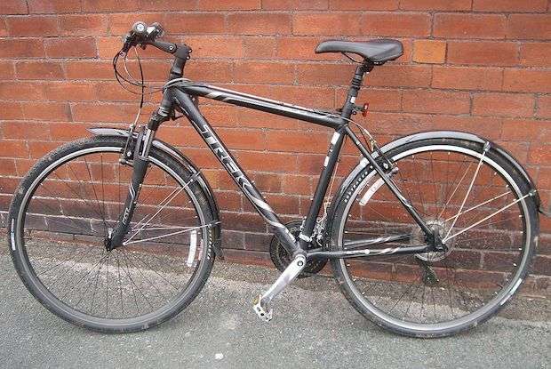 Trek hybrid bike against a brick wall