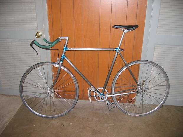 Road bike stripped of paint down to its aluminum frame
