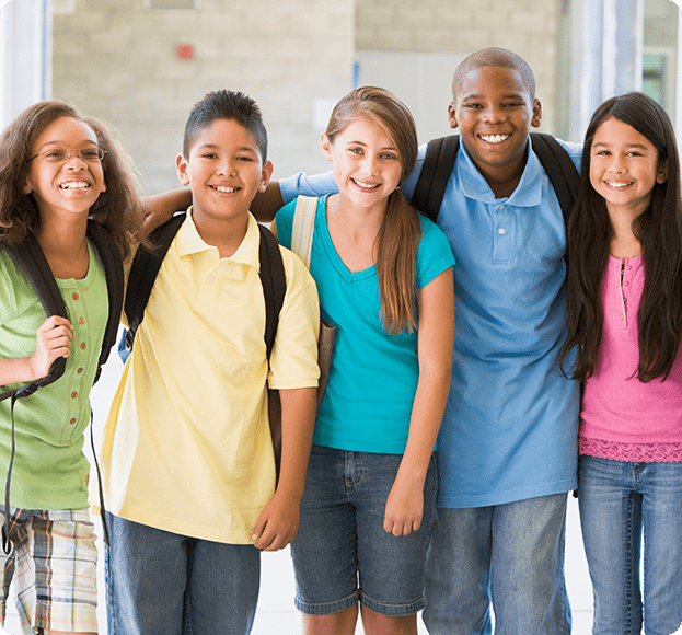 Grade school kids posing for picture with backpacks