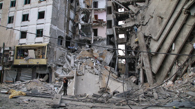 Palestinian citizens inspect damage to their homes caused by Israeli airstrikes in Gaza City.