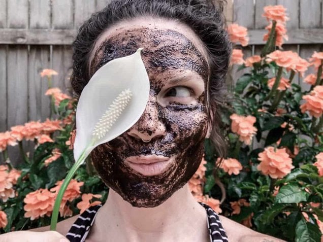 author with honey and coffee grounds face mask on