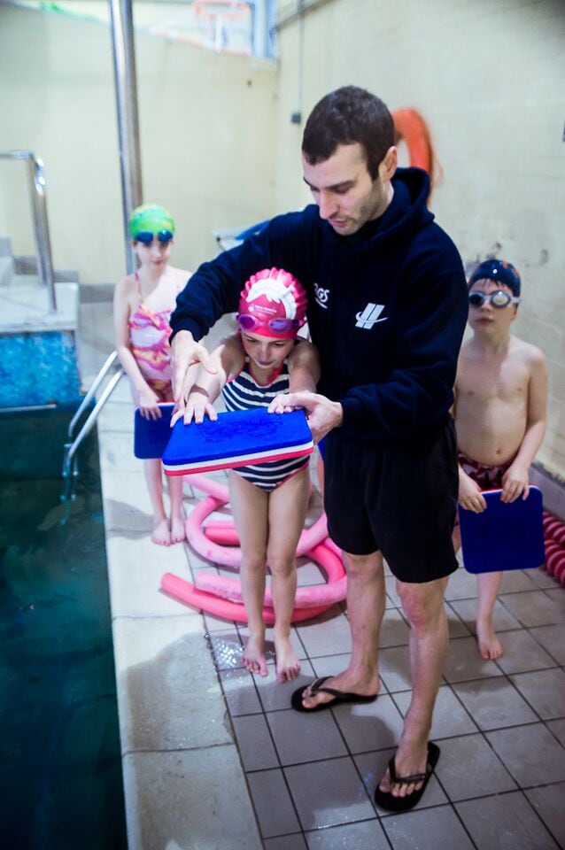 A Swim England qualified swim teacher teaches swimming at Blue Wave Swim School in Wimbledon, London
