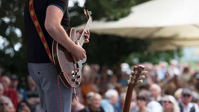 A band plays for a crowd of people.