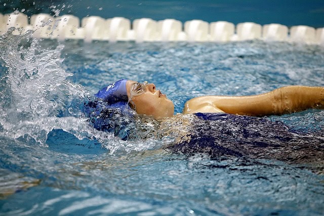 A child swims backstroke