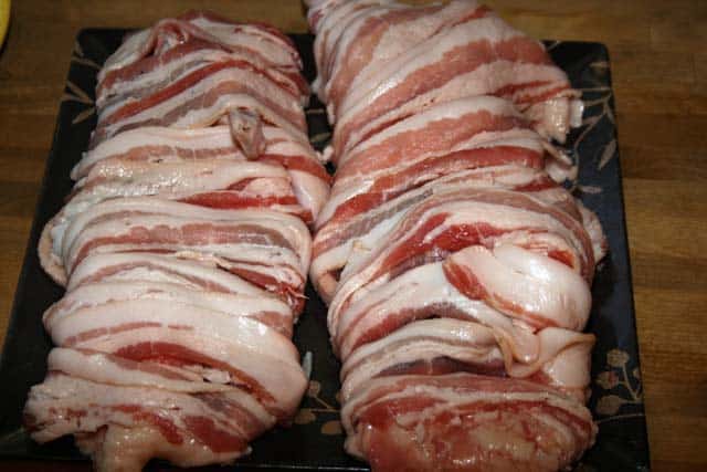 raw duck halves wrapped in bacon