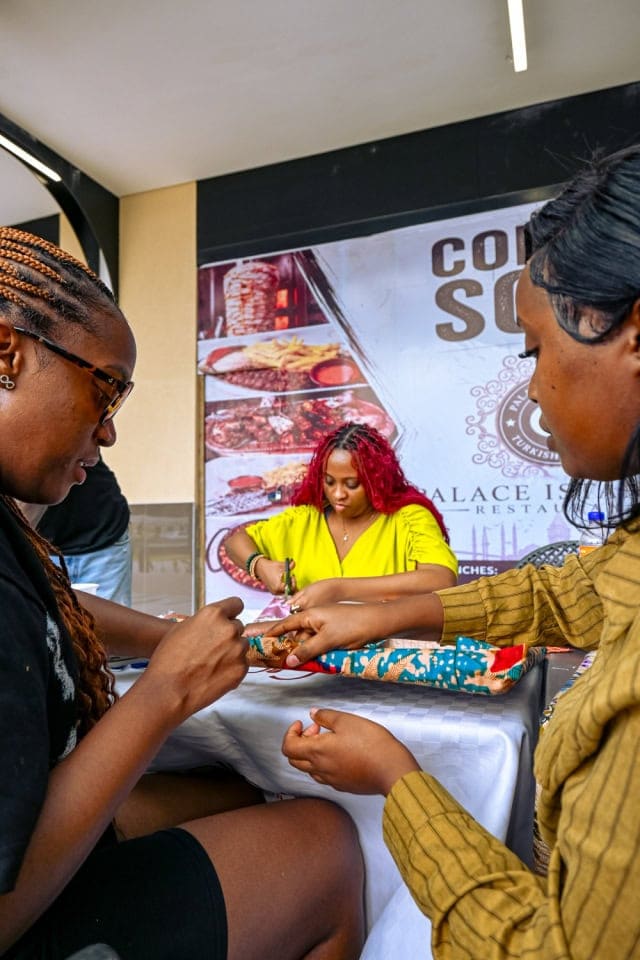 Participants collaborate on a patterned fabric project at the Frame & Fabric Workshop at Galleria