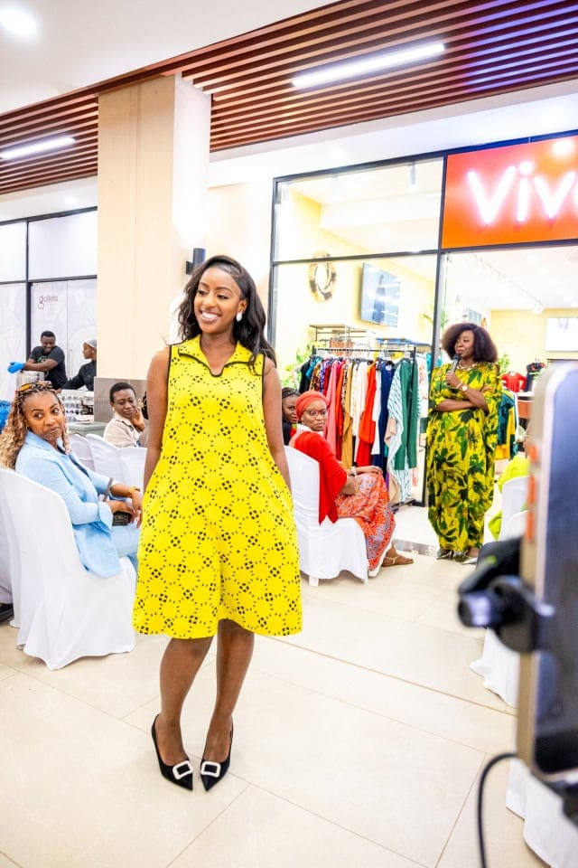 A model presents a bright yellow dress during the Style, Shop & Sip fashion showcase