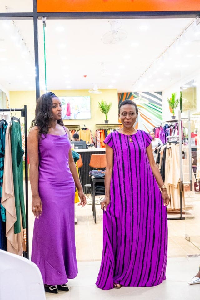 Two guests pose in contrasting purple dresses during Style, Shop & Sip with Connie Oluoch.
