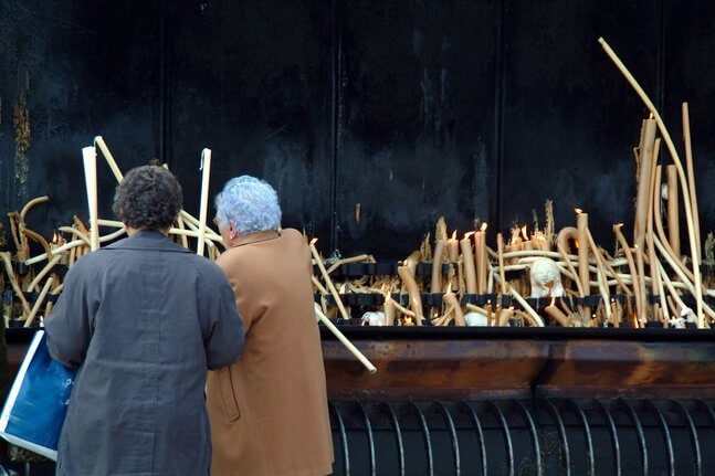 Two ladies on a Fatima pilgrimage in front of a shrine
