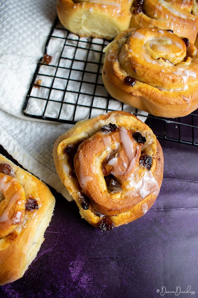 one mincemeat and marzipan Chelsea bun falling off side of wire rack