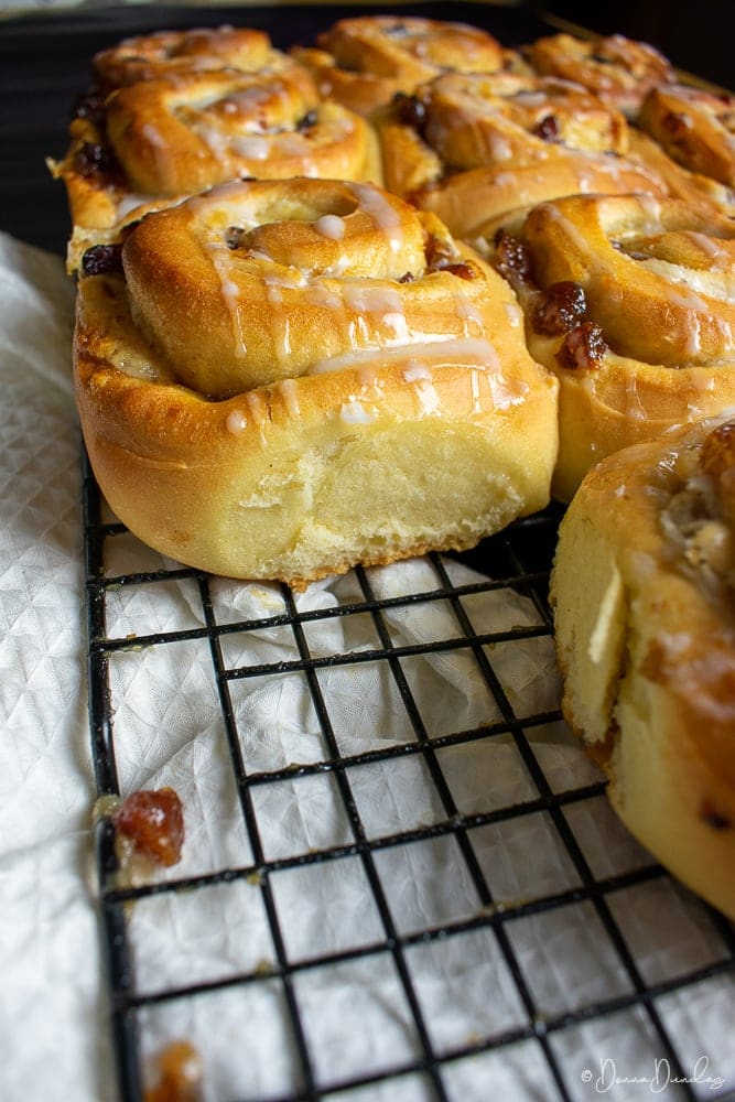 3/4 shot of side of mince chelsea bun on wire rack