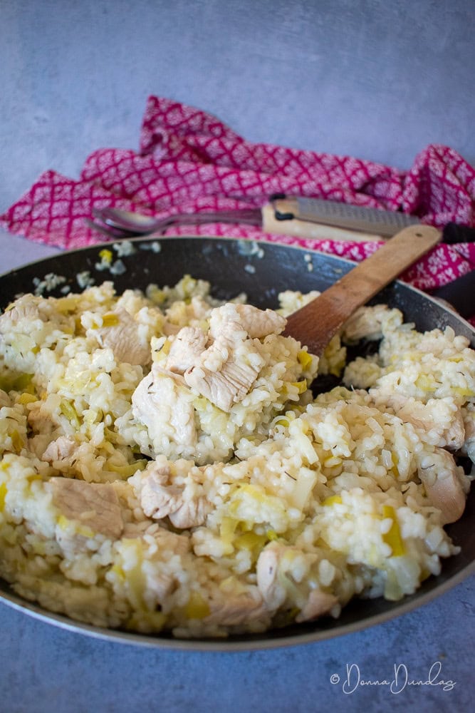 cooked risotto in frying pan.