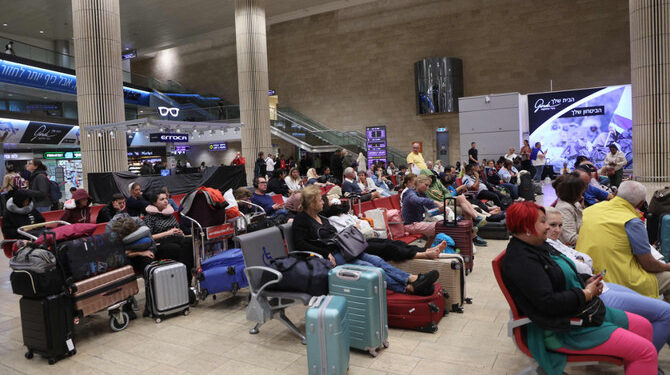 Passengers wait at Ben Gurion Airport near Tel Aviv, Israel, on October 7, 2023, as flights are canceled because of the Hamas surprise attack. (AFP)