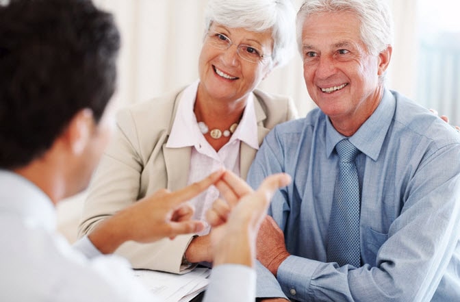 A doctor talking to senior couple