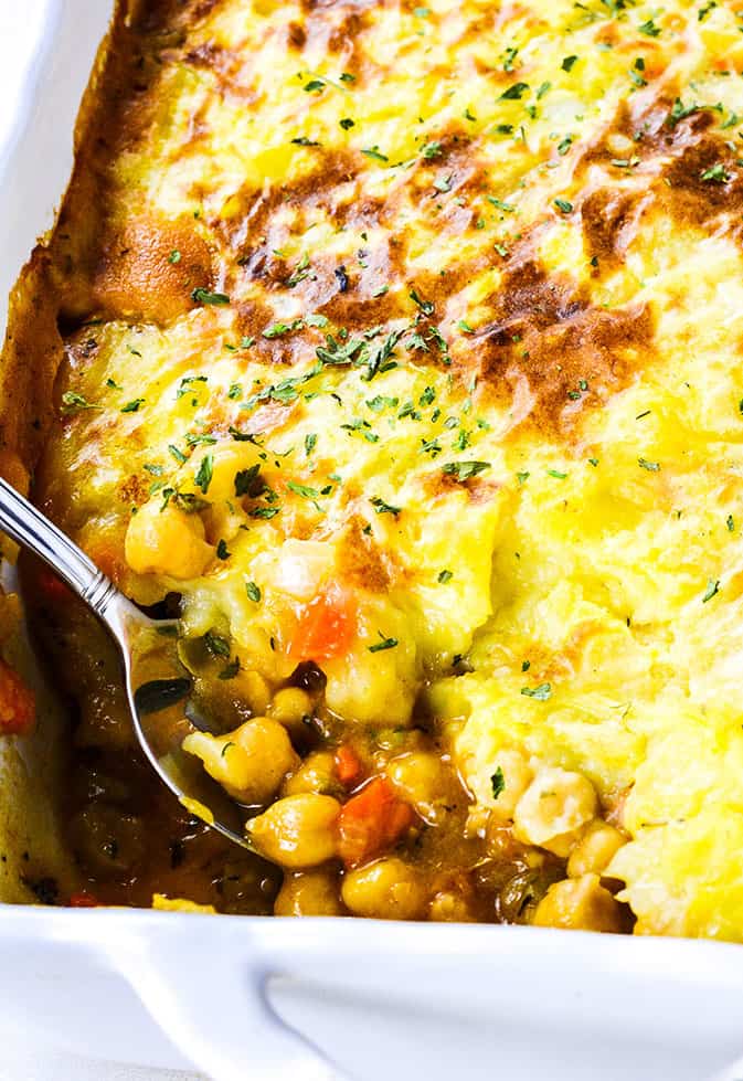 a closeup of a spoon taking out some shepherd's pie