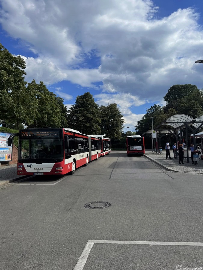 white and red city buses parked at Dachau station