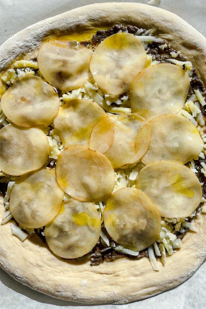 Pre-baked Potato Pizza with Burrata and Truffle topped with the potato layer which has been drizzled with olive oil. To die for! | Paula's Apron Recipe