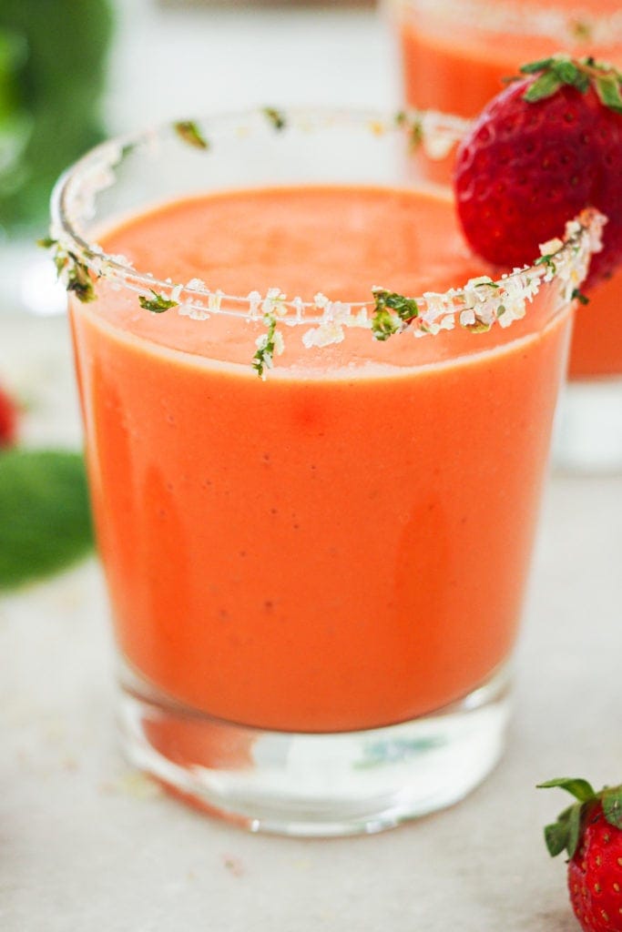 Hot weather calls for no-cook and refreshing recipes, like this Strawberry Gazpacho. It’s quick and easy to put together and a delicious way to use ripe fruit and veggies (or fruit and veggies that don’t look that pretty). It truly tastes absolutely amazing and the salt and mint rimmed glass makes it look even better (and pst! it's naturally vegan, lactose free and can be made gluten-free). | Paula's Apron Recipe