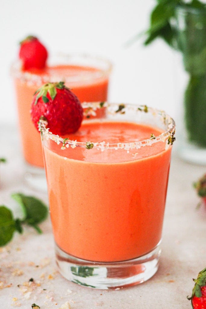 Hot weather calls for no-cook and refreshing recipes, like this Strawberry Gazpacho. It’s quick and easy to put together and a delicious way to use ripe fruit and veggies (or fruit and veggies that don’t look that pretty). It truly tastes absolutely amazing and the salt and mint rimmed glass makes it look even better (and pst! it's naturally vegan, lactose free and can be made gluten-free). | Paula's Apron Recipe