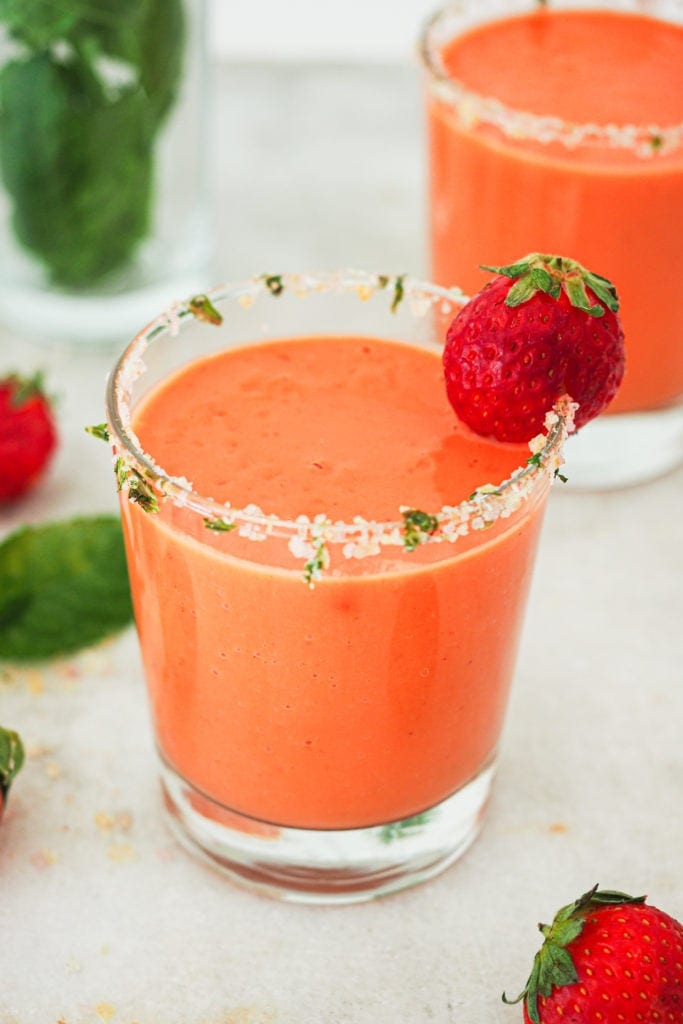 Hot weather calls for no-cook and refreshing recipes, like this Strawberry Gazpacho. It’s quick and easy to put together and a delicious way to use ripe fruit and veggies (or fruit and veggies that don’t look that pretty). It truly tastes absolutely amazing and the salt and mint rimmed glass makes it look even better (and pst! it's naturally vegan, lactose free and can be made gluten-free). | Paula's Apron Recipe