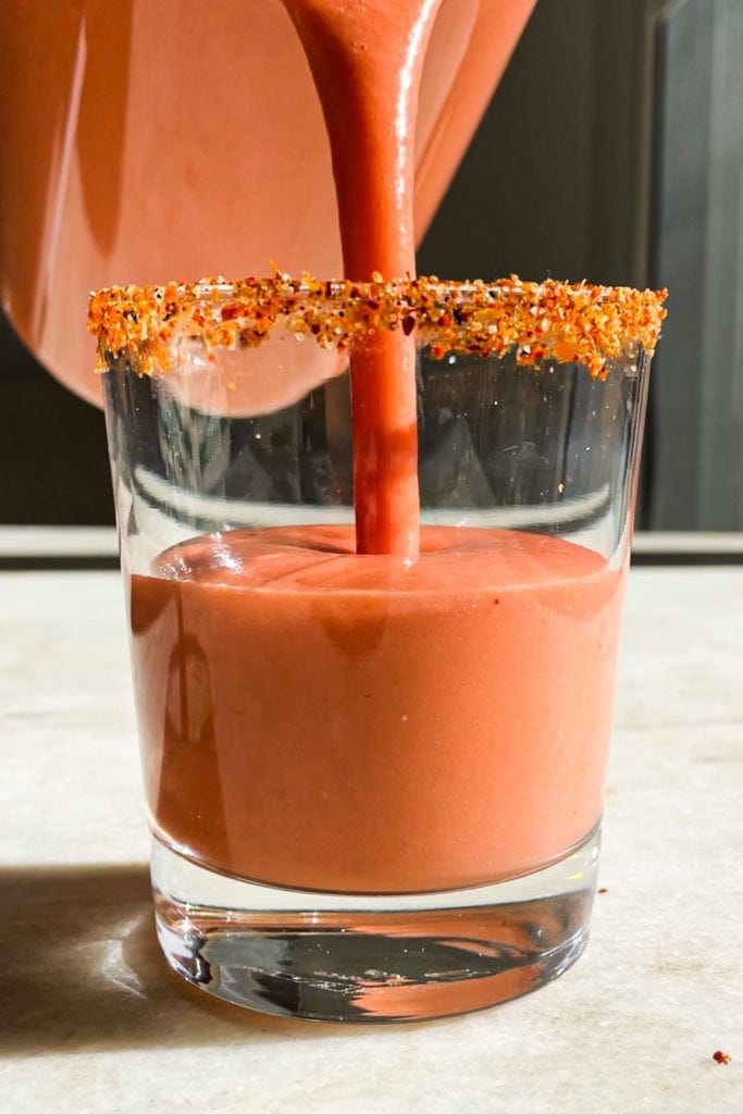 Hot weather calls for no-cook and refreshing recipes, like this Strawberry Gazpacho. It’s quick and easy to put together and a delicious way to use ripe fruit and veggies (or fruit and veggies that don’t look that pretty). It truly tastes absolutely amazing and the tajin rimmed glass makes it look even better (and pst! it's naturally vegan, lactose free and can be made gluten-free). | Paula's Apron Recipe