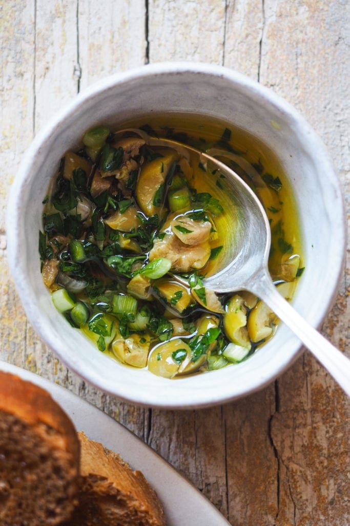 Spicy Lemony Olives Topping with spring onion, parsley, chili flakes, lemon zest and garlic confit oil, perfect to top dips, grilled fish and pasta. | Paula's Apron Recipe