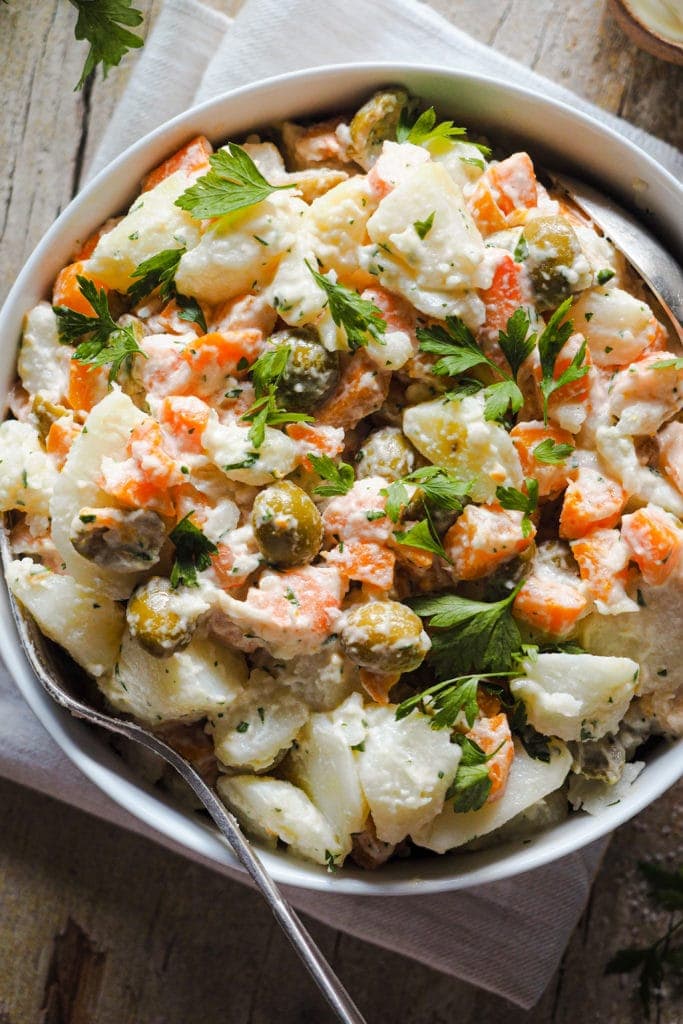 This Creamy Potato Salad with Prawns is my grandma's staple potato salad. It calls for potatoes, carrots, green olives and prawns cut into pieces, all seasoned with homemade mayonnaise and a touch of fresh chopped parsley. It's creamy and filling without being heavy, healthy, nutritious and delicious. It's the ultimate summer salad and you can also prepare it in advance! | Paula's Apron Recipe