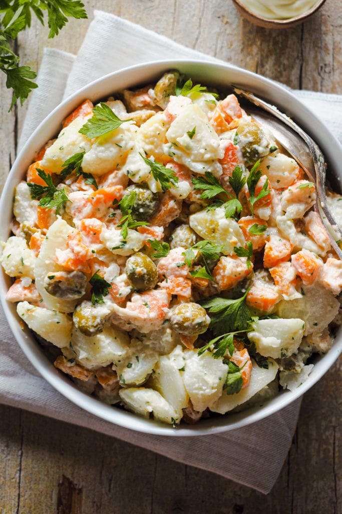 This Creamy Potato Salad with Prawns is my grandma's staple potato salad. It calls for potatoes, carrots, green olives and prawns cut into pieces, all seasoned with homemade mayonnaise and a touch of fresh chopped parsley. It's creamy and filling without being heavy, healthy, nutritious and delicious. It's the ultimate summer salad and you can also prepare it in advance! | Paula's Apron Recipe