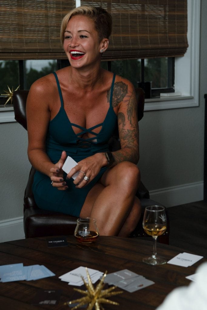 Woman sipping Quintaliza Tequila at a party with friends