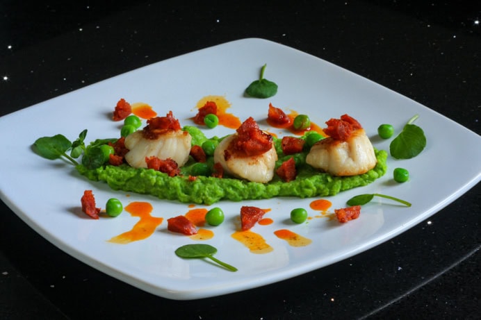 Seared scallops with chorizo and pea purée recipe.