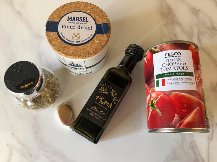 ingredients for the pizza sauce recipe - salt, oregano, olive oil, garlic and a tin of tomatoes