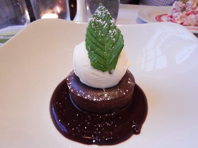 review Dark chocolate fondant with chocolate sauce and vanilla ice-cream