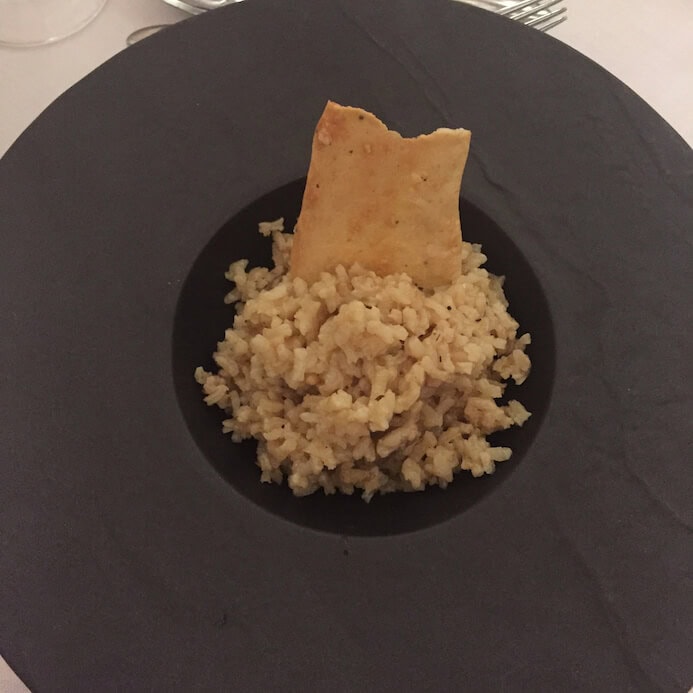 A plate of dry bland grey looking risotto