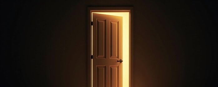 A closed door with light coming from underneath, symbolizing hesitation to start something new.