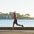 man running near sea during daytime