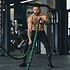 Athletic young man with battle rope doing exercise