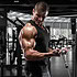 Muscular man working out in gym doing exercise for biceps, strong male bodybuilder