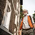 Senior man on the street. Elderly cool man listening to music outdoors, having fun. Concept of old