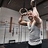 Smiling man resting after exercising on rings at the gym