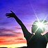 Mental health concept, Girl female holding her hands in the air at sunset with bright light on head.